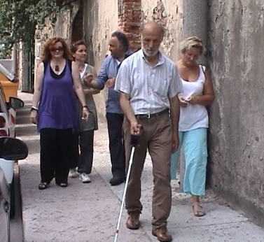 Persona non vedente con istruttori di mobilità durante un corso a Verona